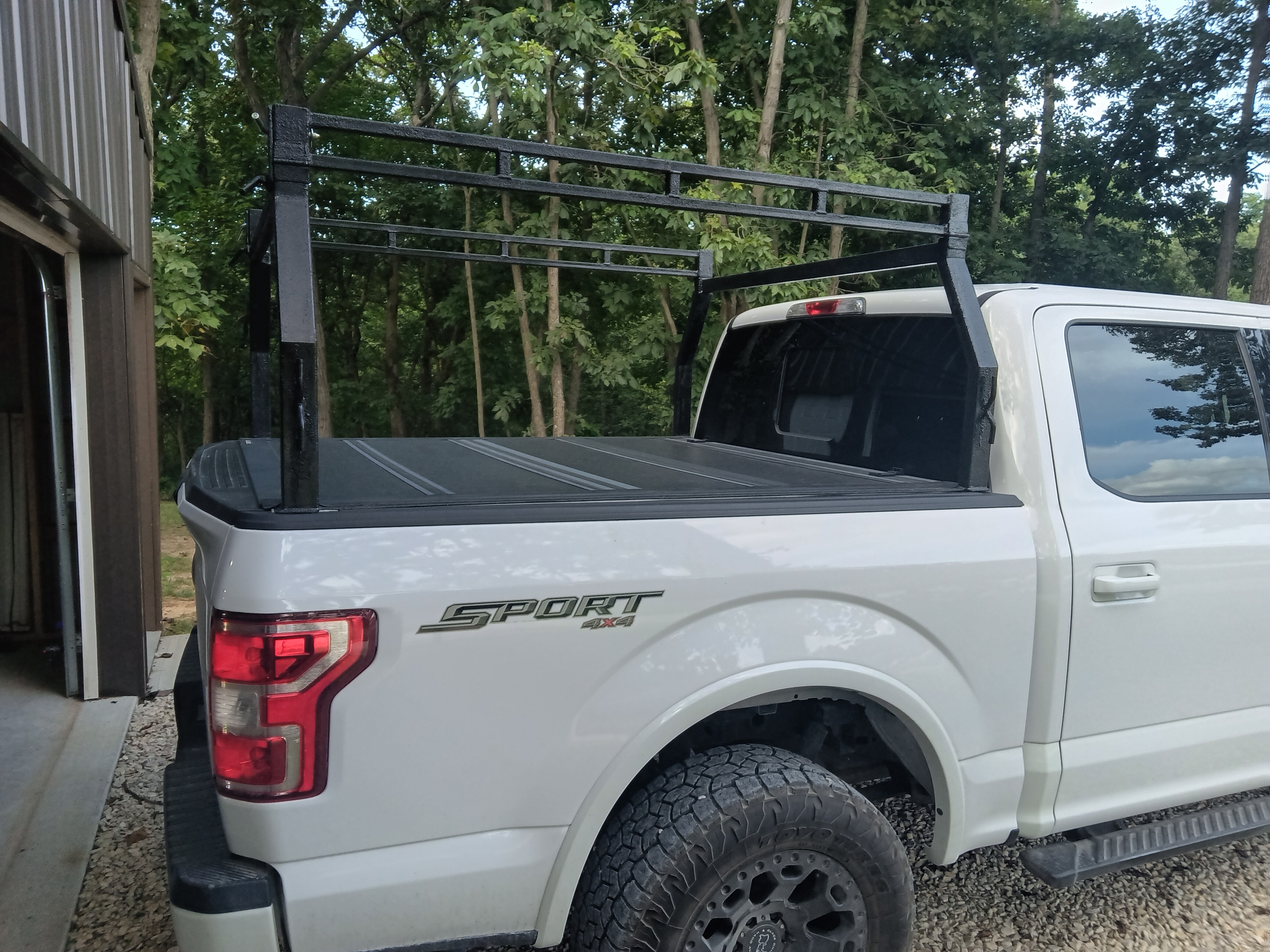 T~RAX headache rack on white F-150 Sport, rear quarter